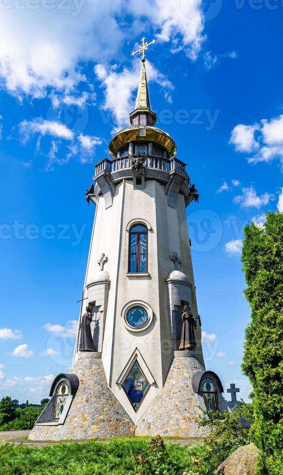 Christian church cross in high steeple tower for prayer photo