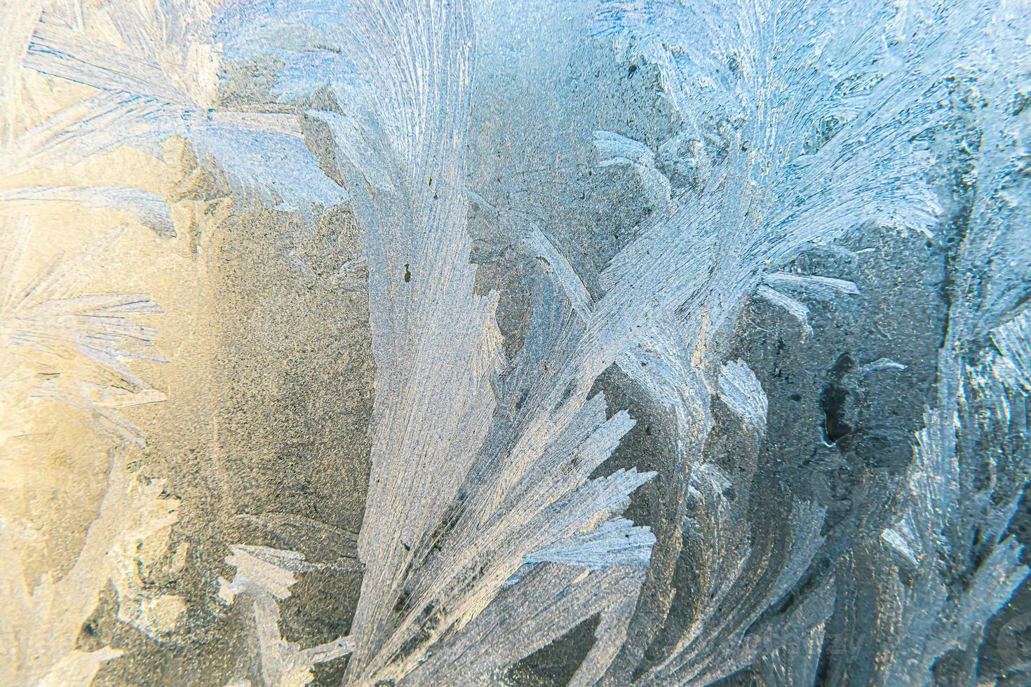 Frozen winter window with shiny ice frost pattern texture. Christmas wonder symbol, abstract background. Extreme north low temperature, natural Ice snow on frosty glass, cool winter weather outdoor. photo