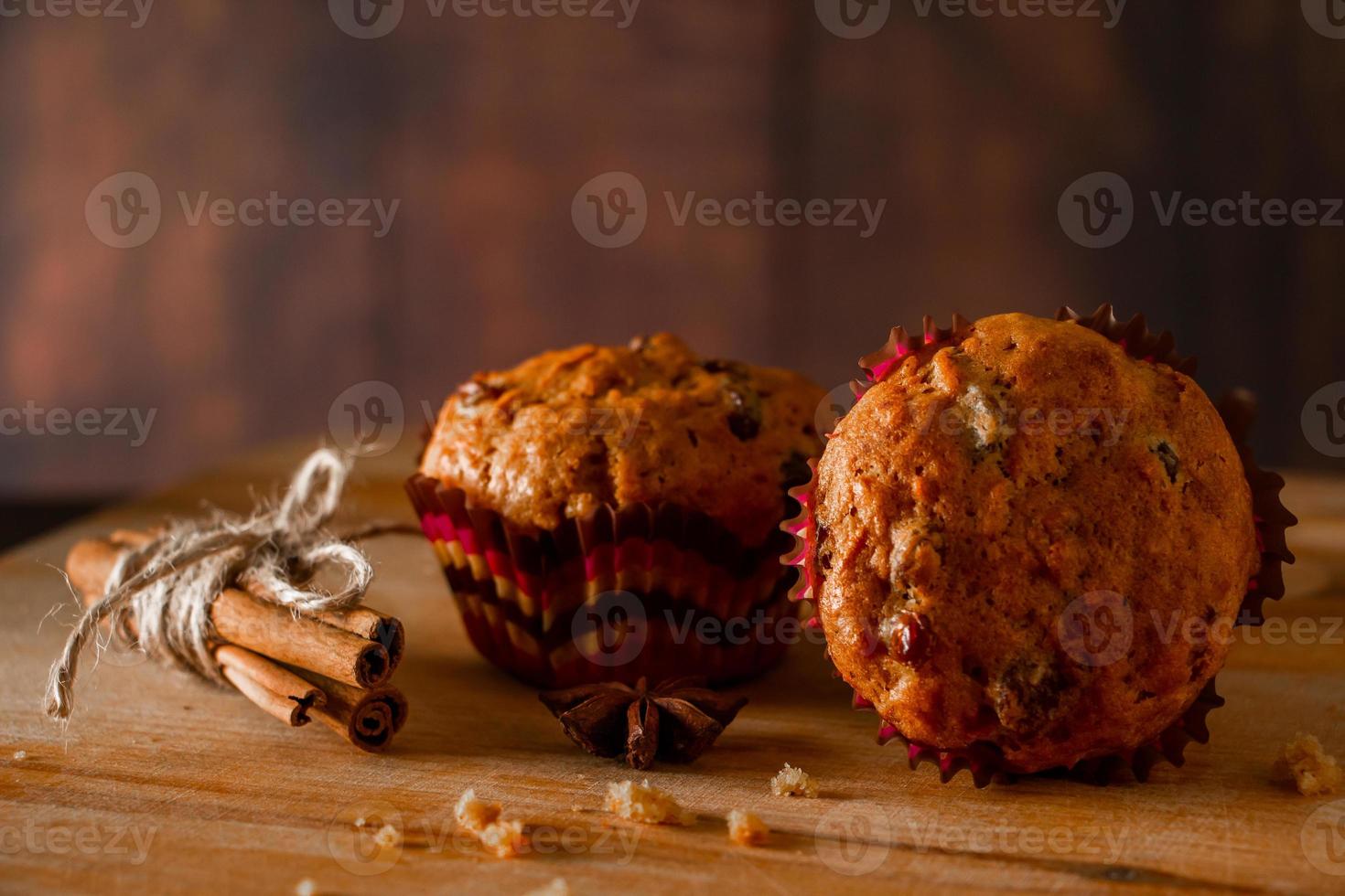 Homemade muffins with raisins. Christmas baking on a wooden background. photo