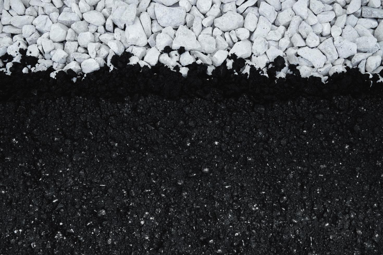 New asphalt on white gravel. Top down view flat background of freshly laid asphalt. photo