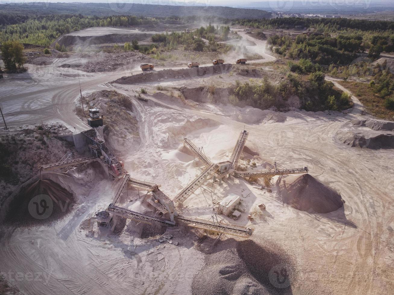 Aerial view of crushed stone quarry machine at work. photo