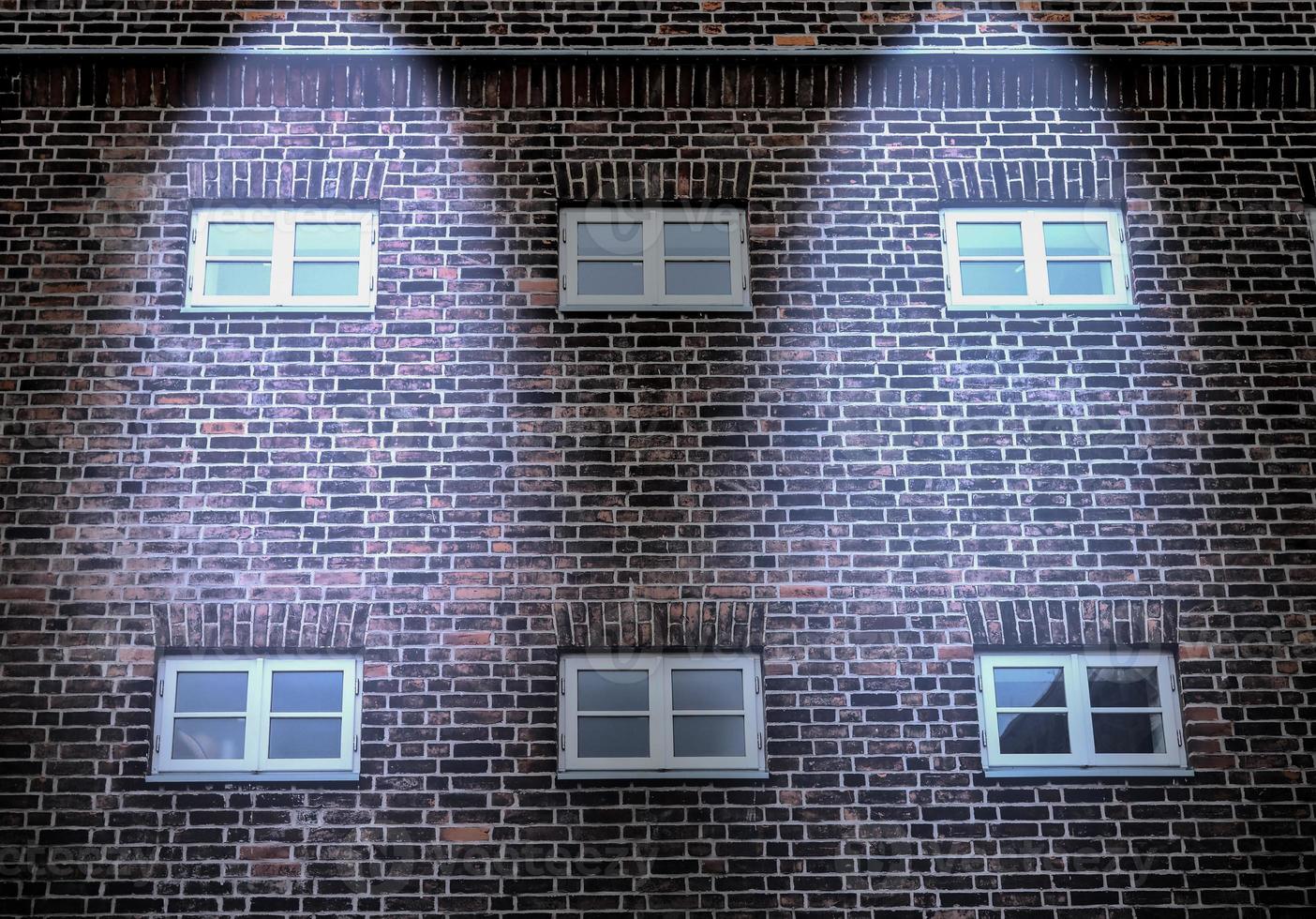 Aged and weathered brick wall textures with very bright spotlight illumination photo