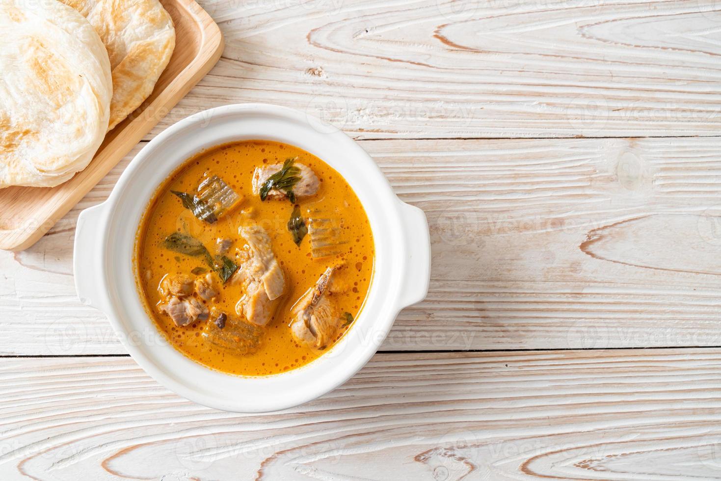 Chicken curry soup with roti photo