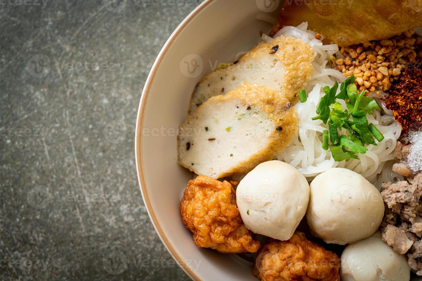 spicy small flat rice noodles with fish balls and shrimp balls without soup photo