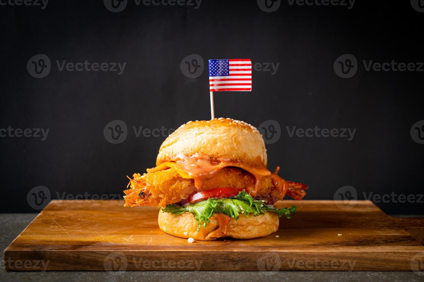 fried shrimps burger on wood tray photo