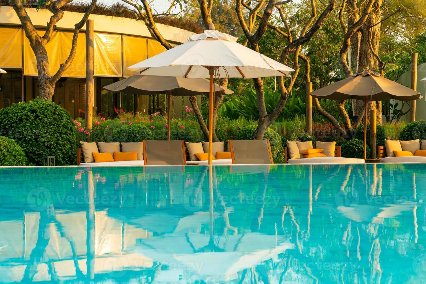 umbrella with bed pool around swimming pool with ocean sea background