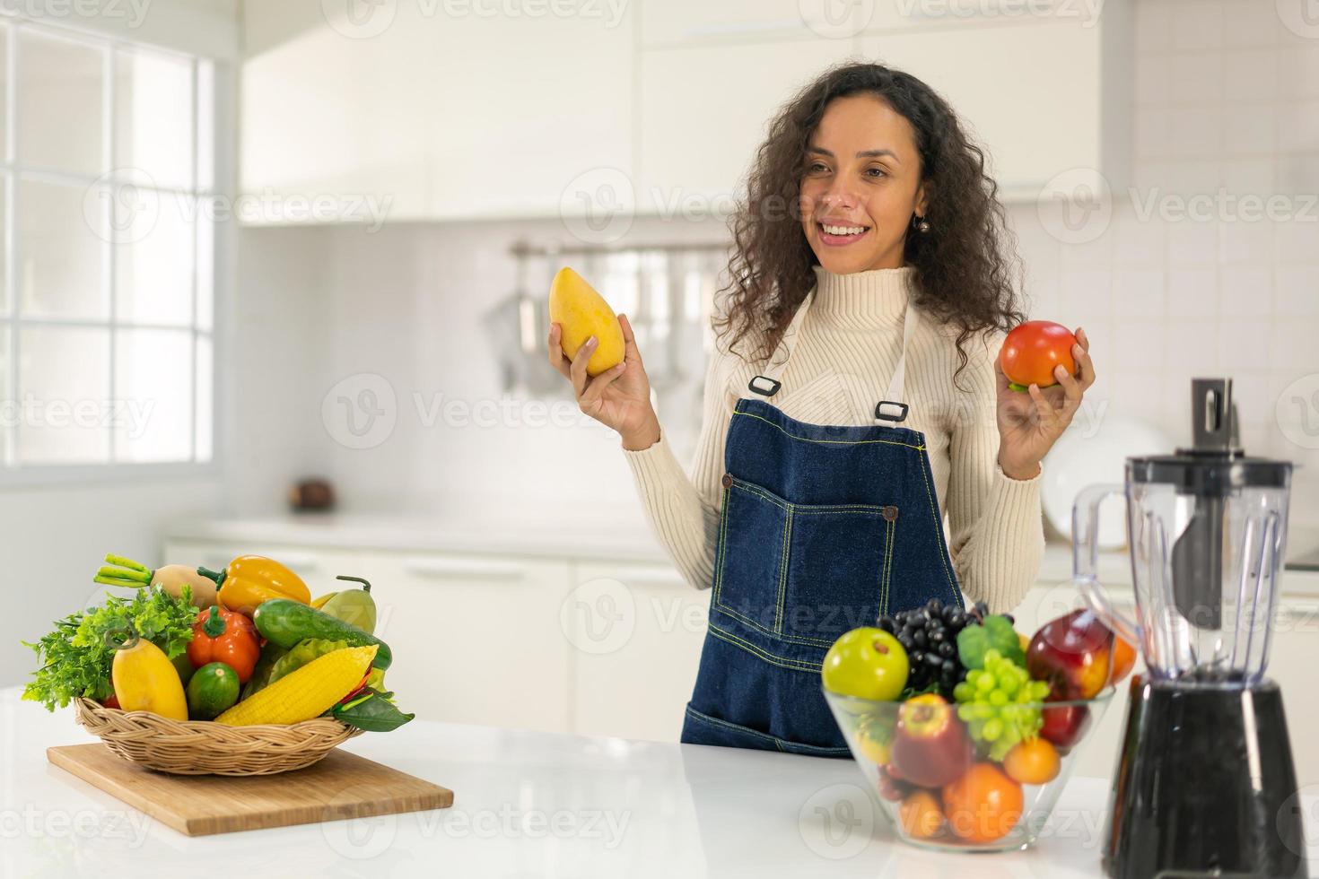 Latin woman making juice in kitchen 12827835 Stock Photo at Vecteezy