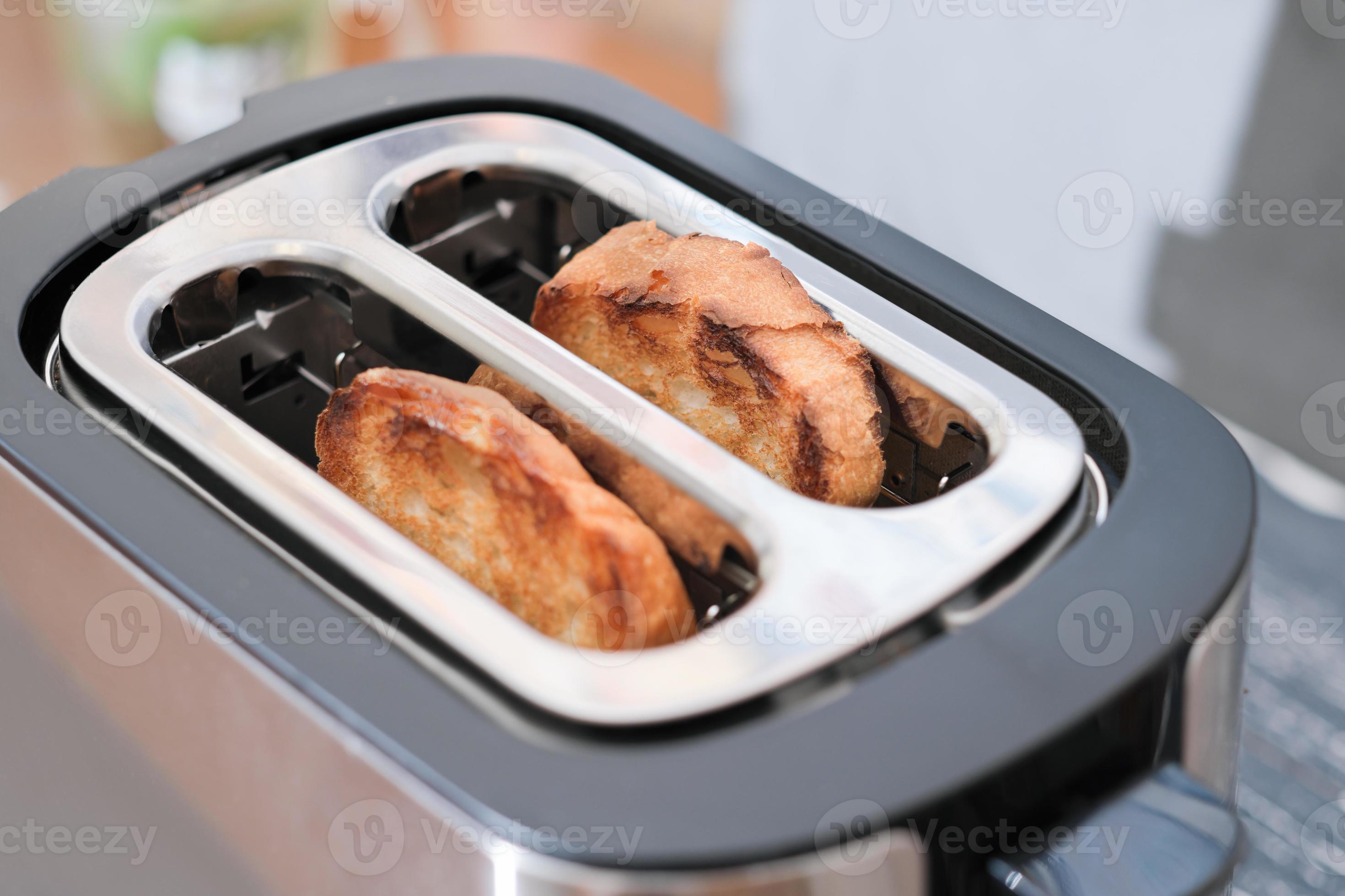 two ready toasts in a toaster. ready crusty bread for morning