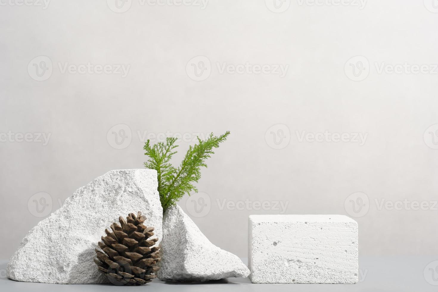 minimal stone podium for product presentation with pine cone and green grass. natural eco product display showcase. photo