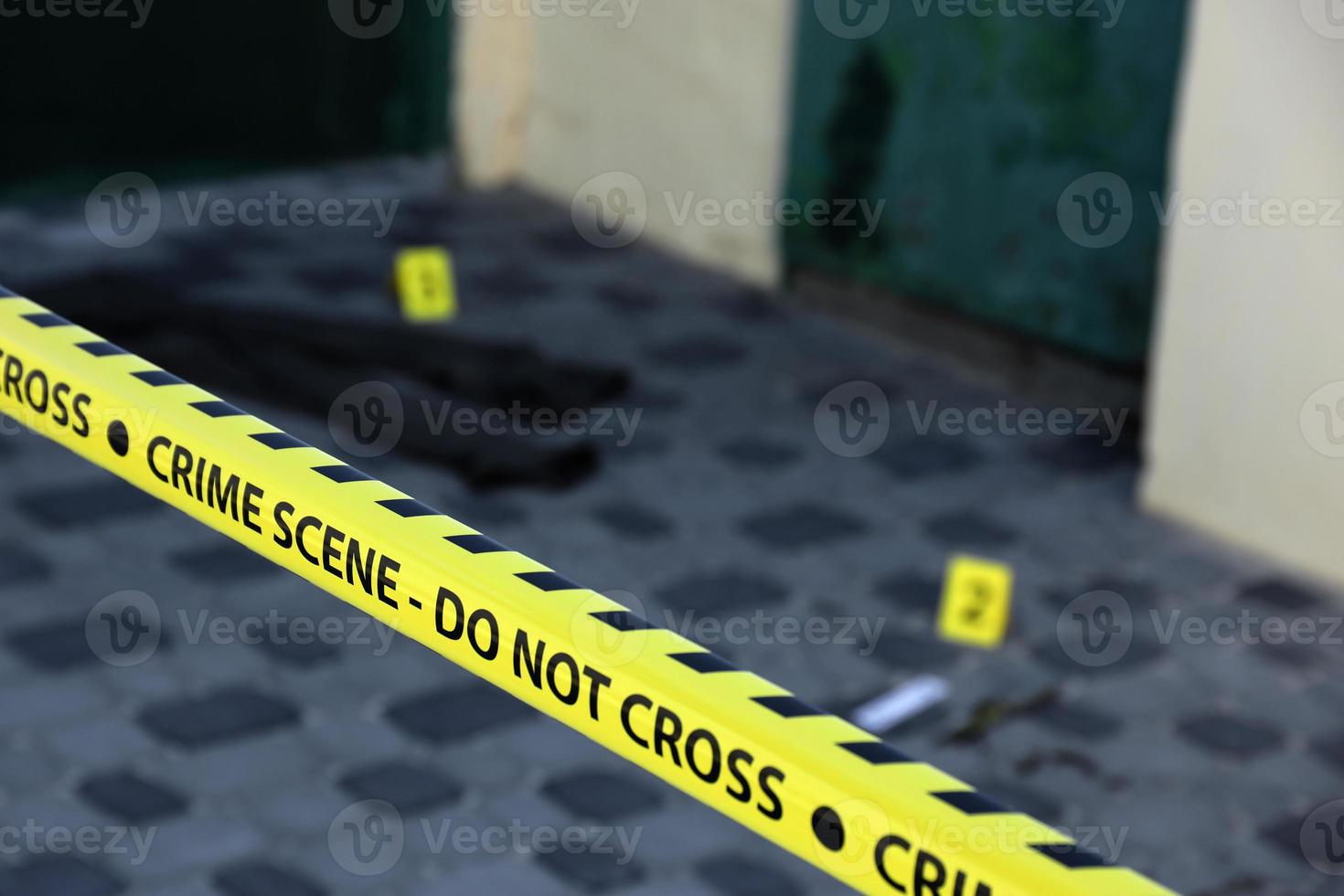 Crime scene tape for covering the area cordon. Yellow tape with blurred forensic law enforcement background in cinematic tone photo