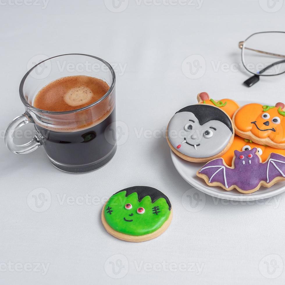 hot espresso coffee  or chocolate cup with funny Halloween Cookies. Happy Halloween day, Trick or Threat, Hello October, fall autumn, Traditional, party and holiday concept photo