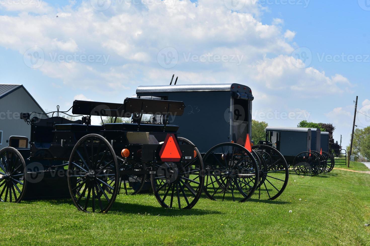 Amish Carts and Buggies Parked at a Farm photo