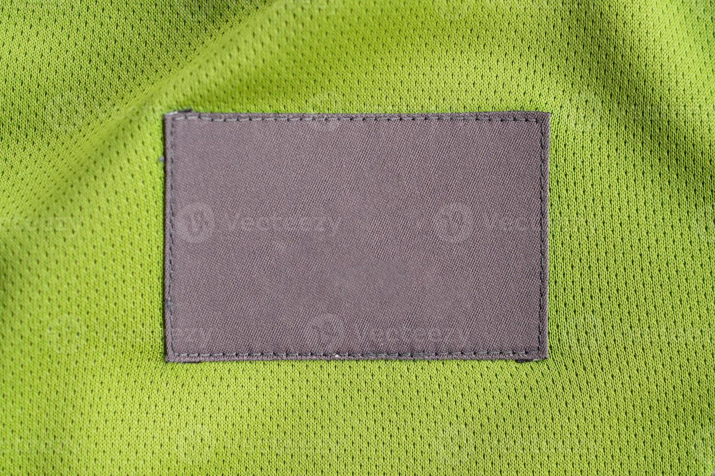 laundry care clothing label patch on polyester fabric jersey sport texture photo