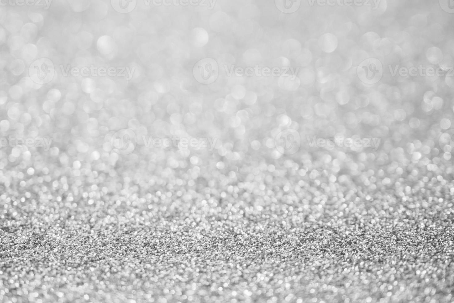Abstract blur silver glitter sparkle defocused bokeh light background photo