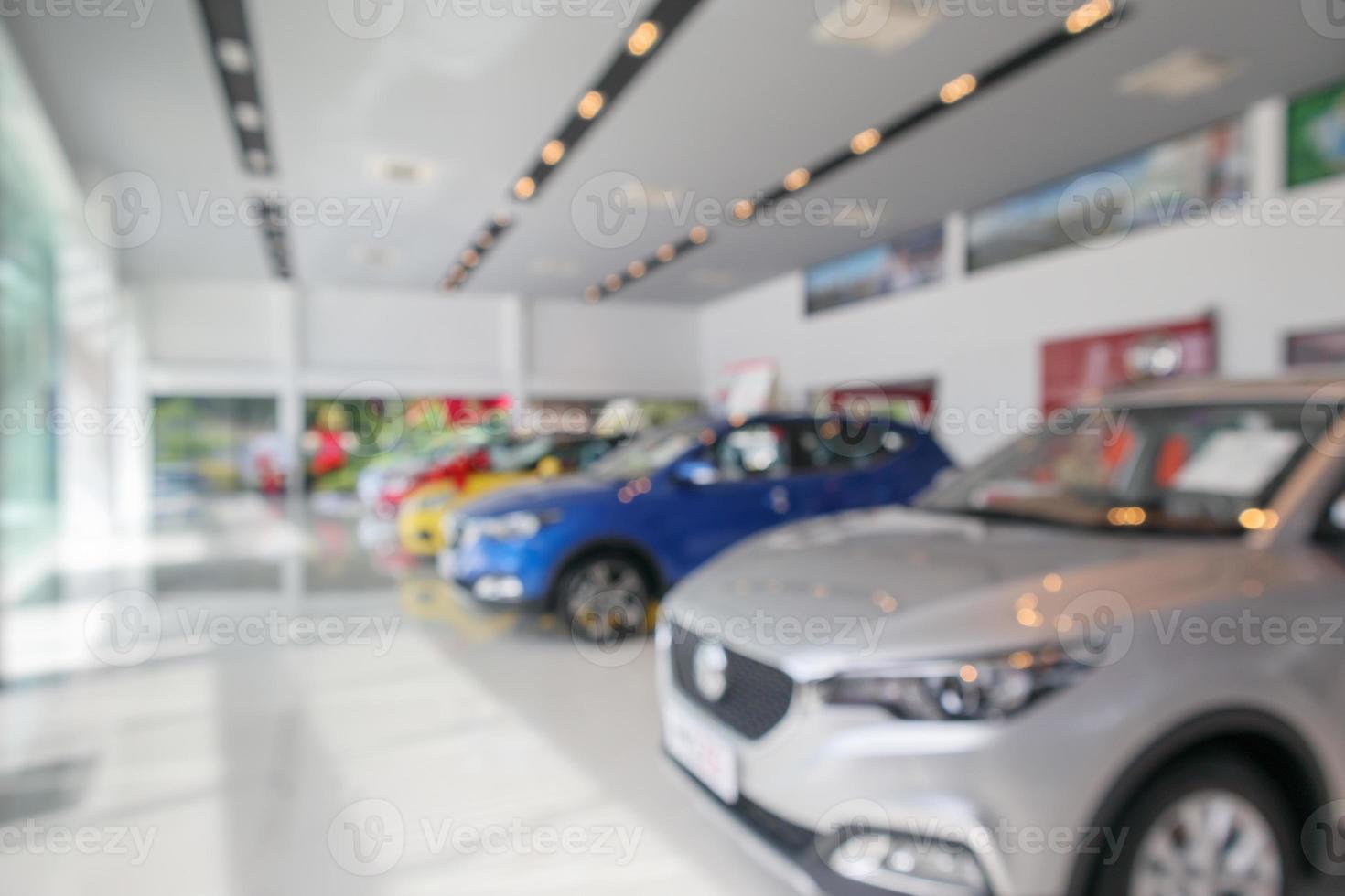 new cars in showroom blurred defocused background photo