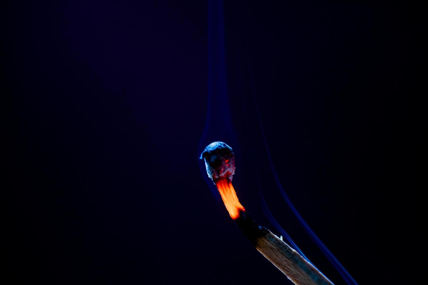 Smoke from burning matchsticks on a black background photo