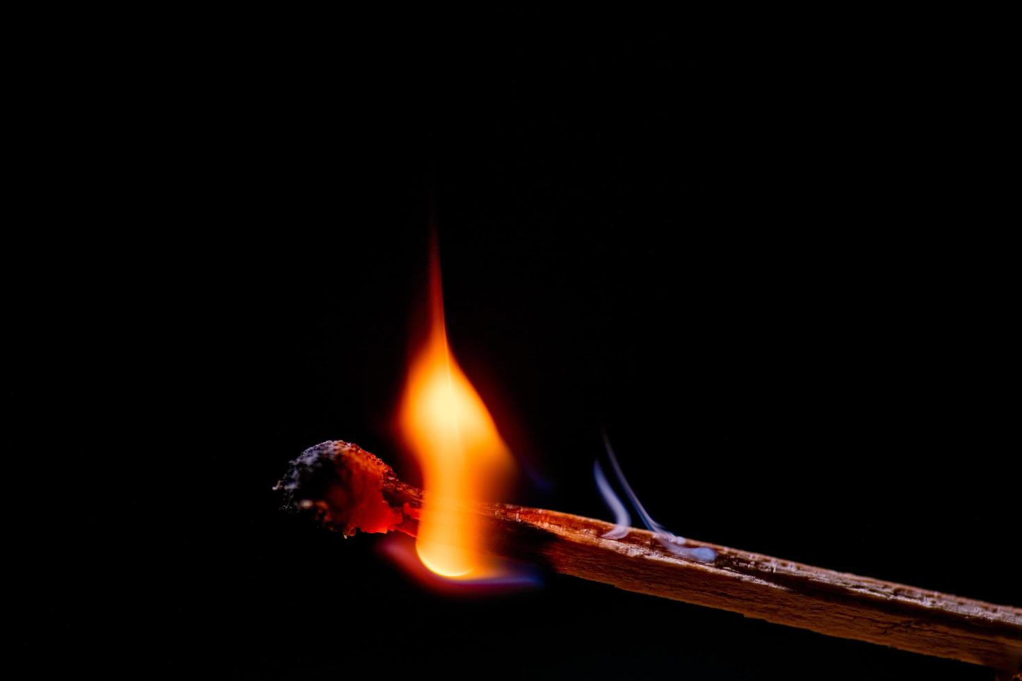 Smoke from burning matchsticks on a black background photo