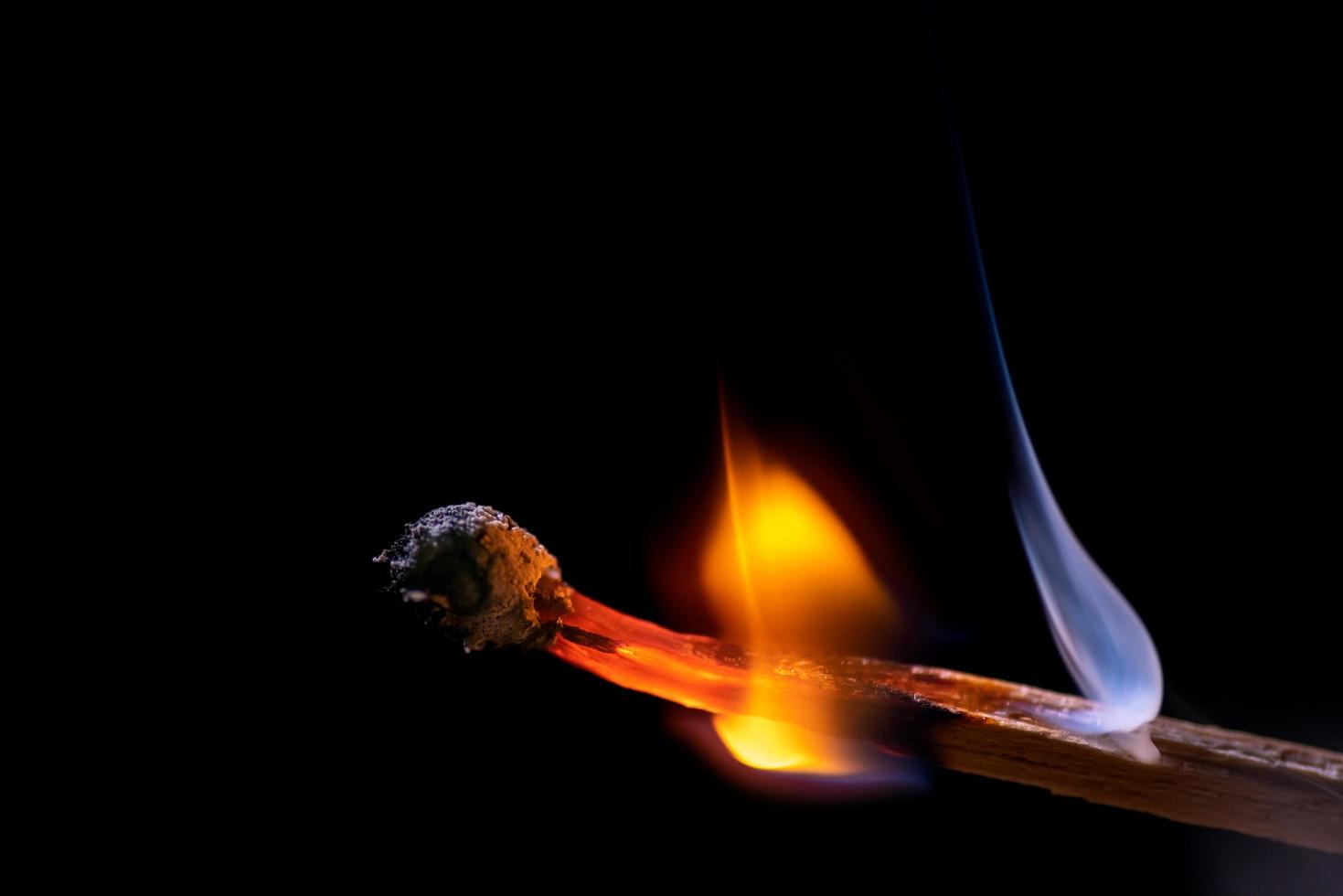 Smoke from burning matchsticks on a black background photo