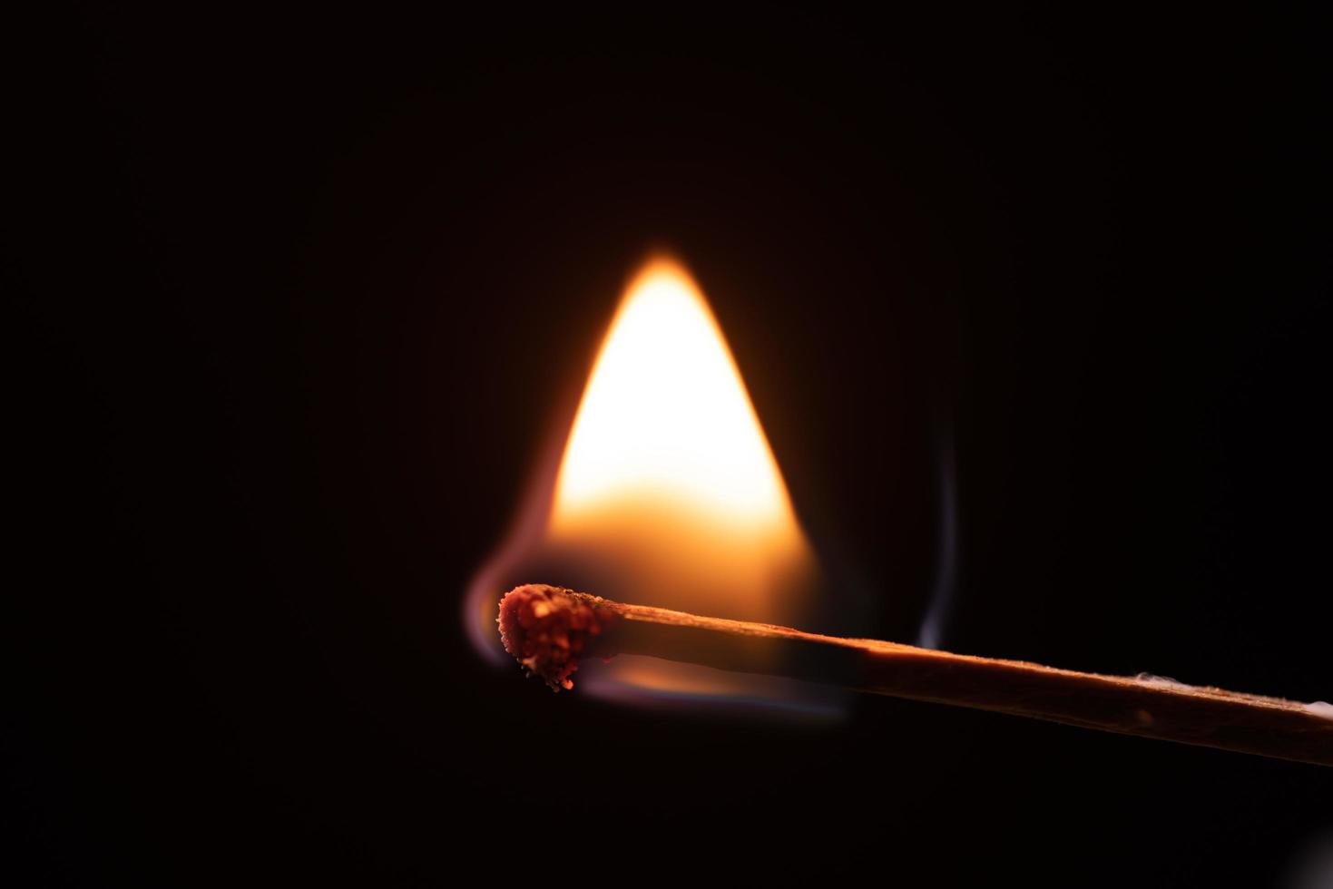 Smoke from burning matchsticks on a black background photo