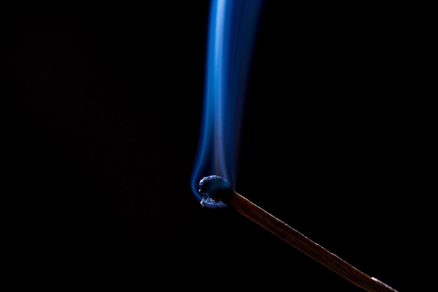 Smoke from burning matchsticks on a black background photo