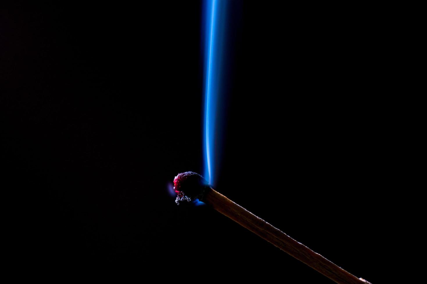 Smoke from burning matchsticks on a black background photo