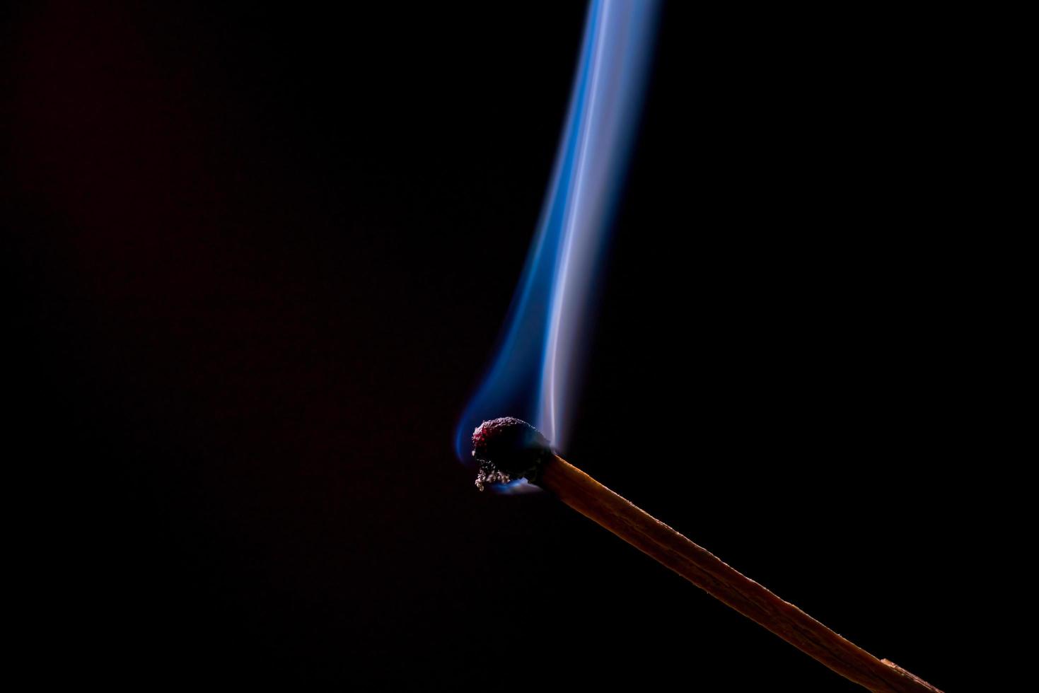 Smoke from burning matchsticks on a black background photo