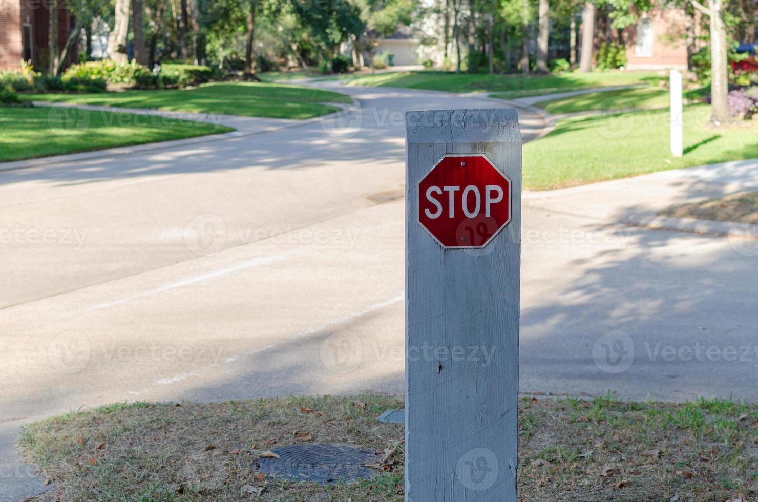 A red stop sign on a post intended for pedestrians. photo