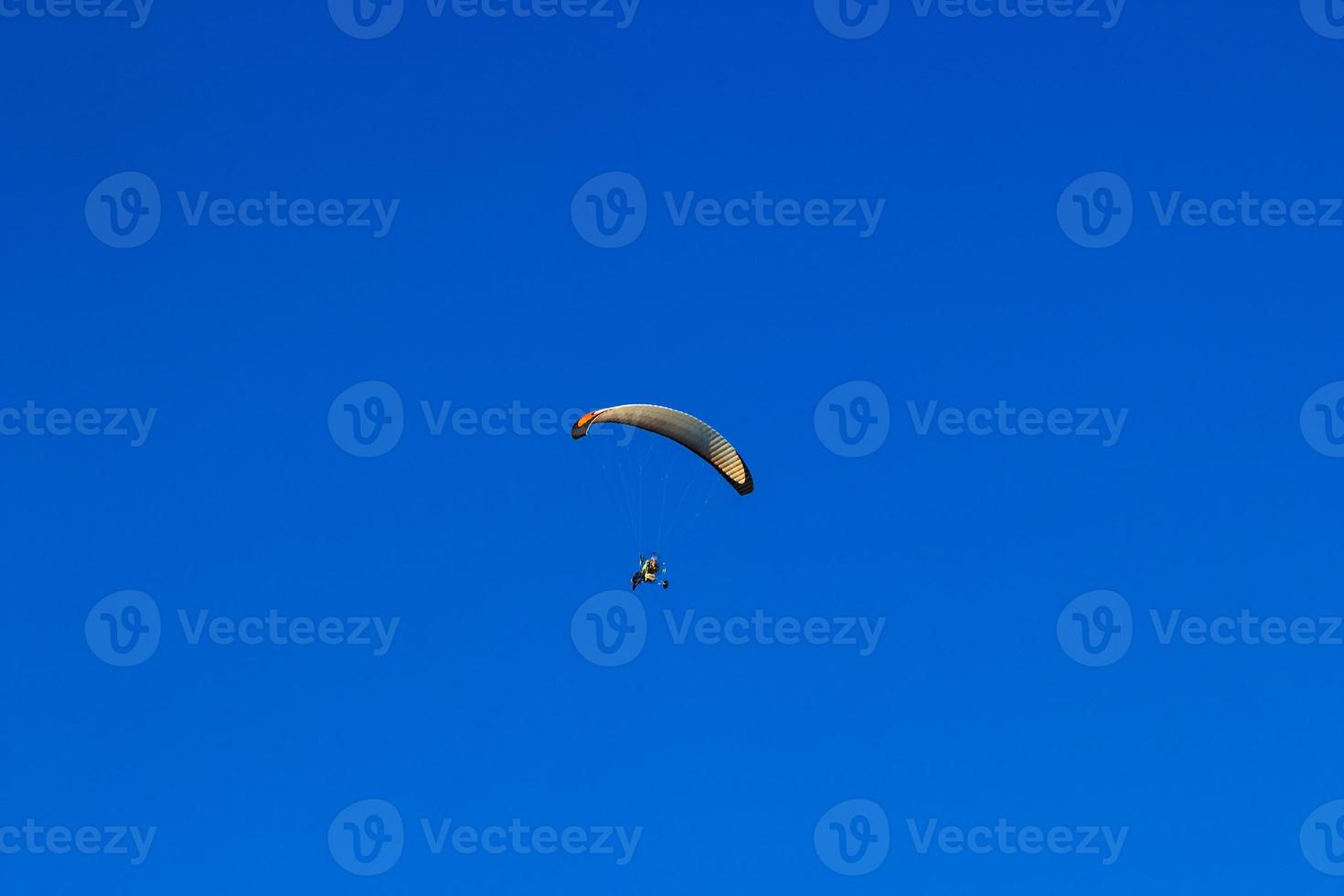 Flying with a para-glider in a clean day. Horizontal image. photo