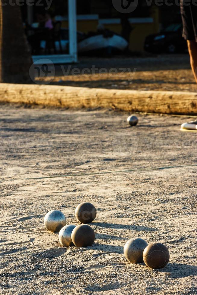 Game of petanque on the ground. Verical image. photo