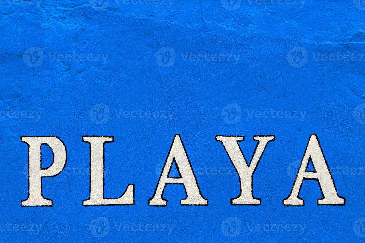 White playa sign painted on a blue wall. Horizontal image. photo