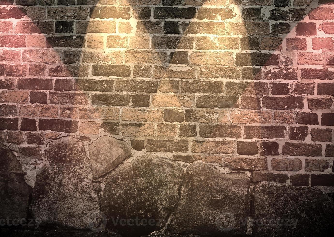 Aged and weathered brick wall textures with very bright spotlight illumination photo