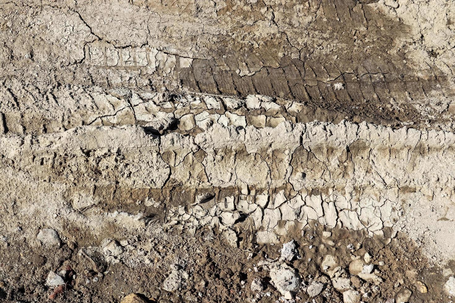 Close up on tire tracks on a muddy road. photo