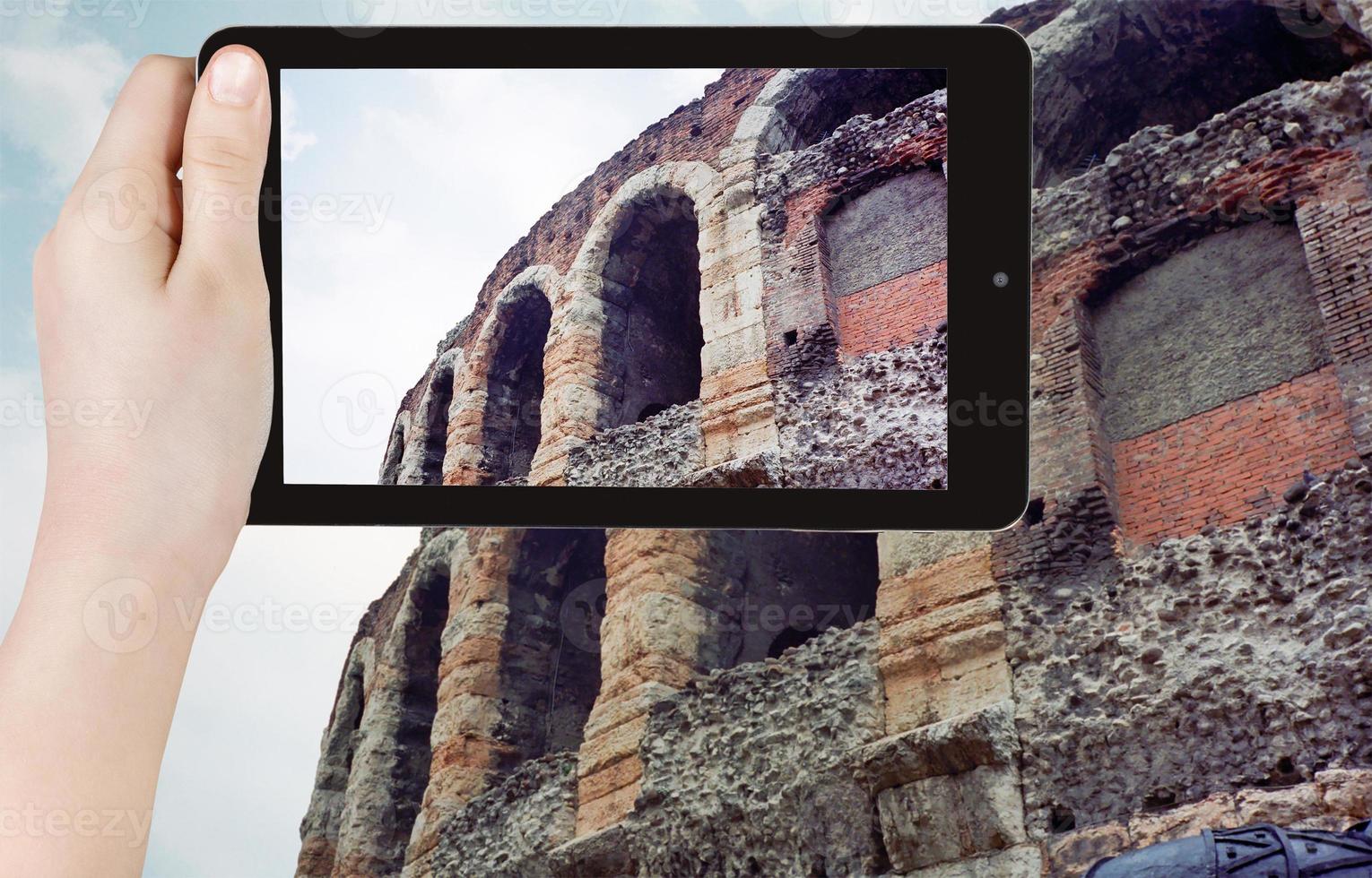 tourist taking photo of roman arena in Verona