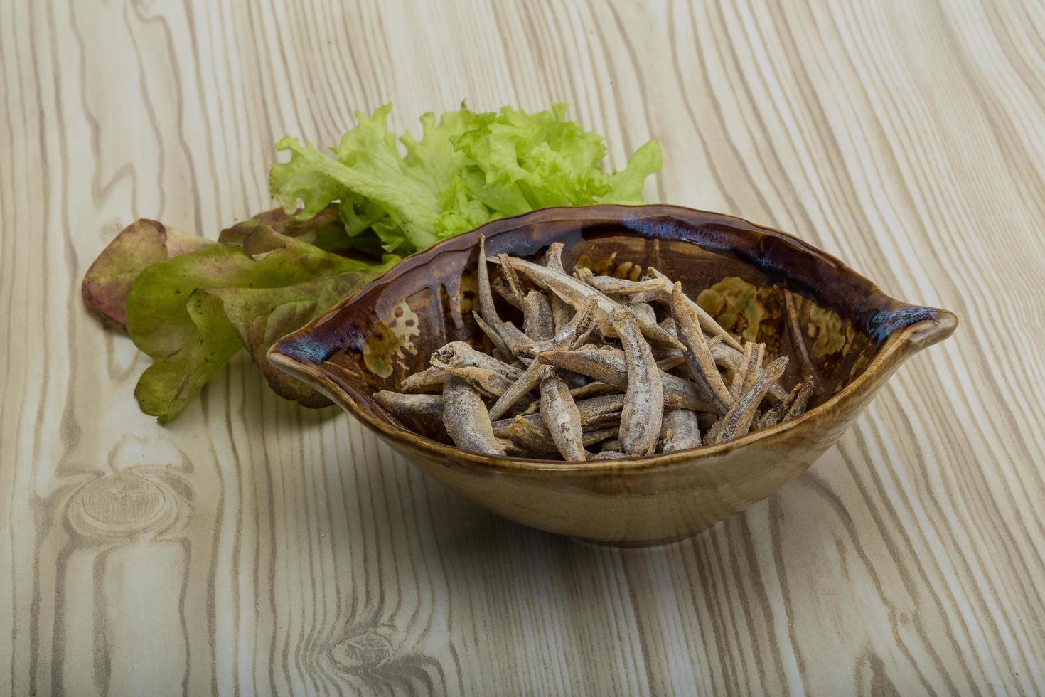 Dries anchovy on wood photo