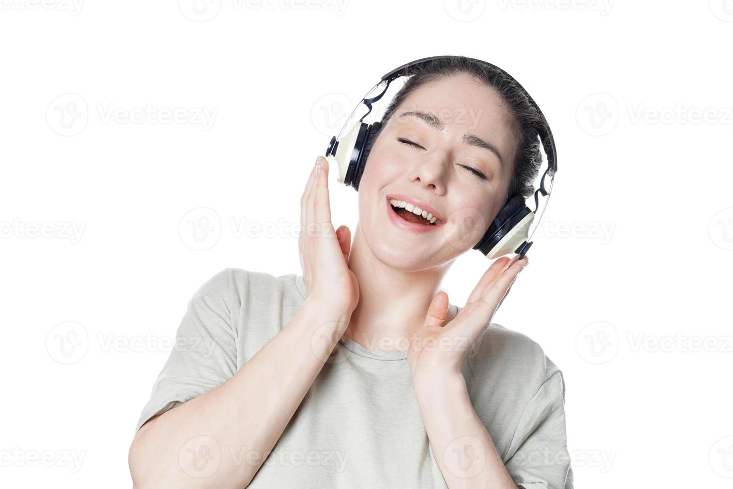 mujer joven feliz escuchando música con auriculares foto