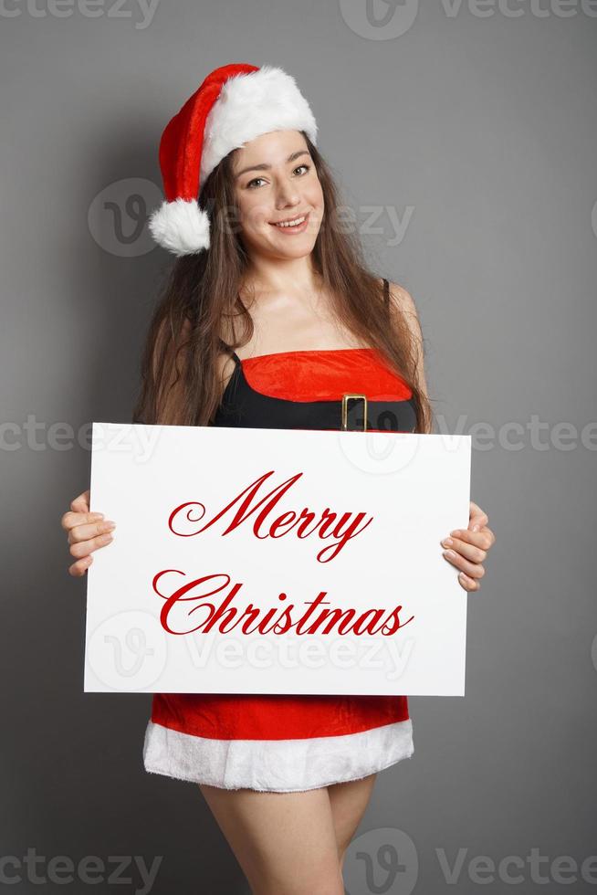 merry christmas woman dressed in xmas costume and santa hat photo