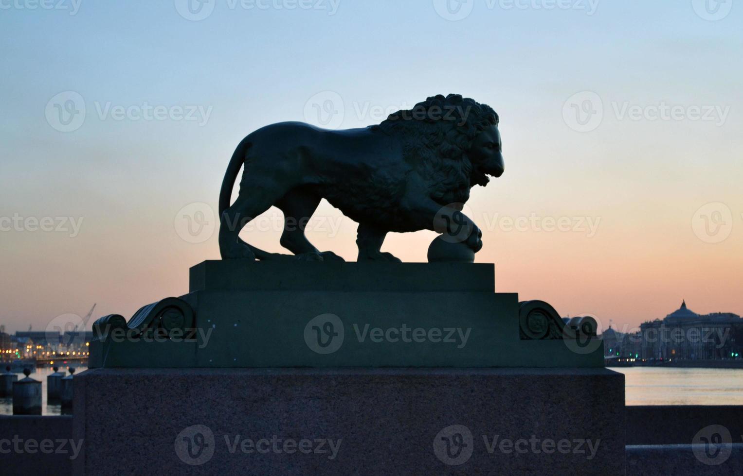 St. Petersburg. In the photo, the evening city of St. Petersburg. View of the embankment and the monument with a lion. photo