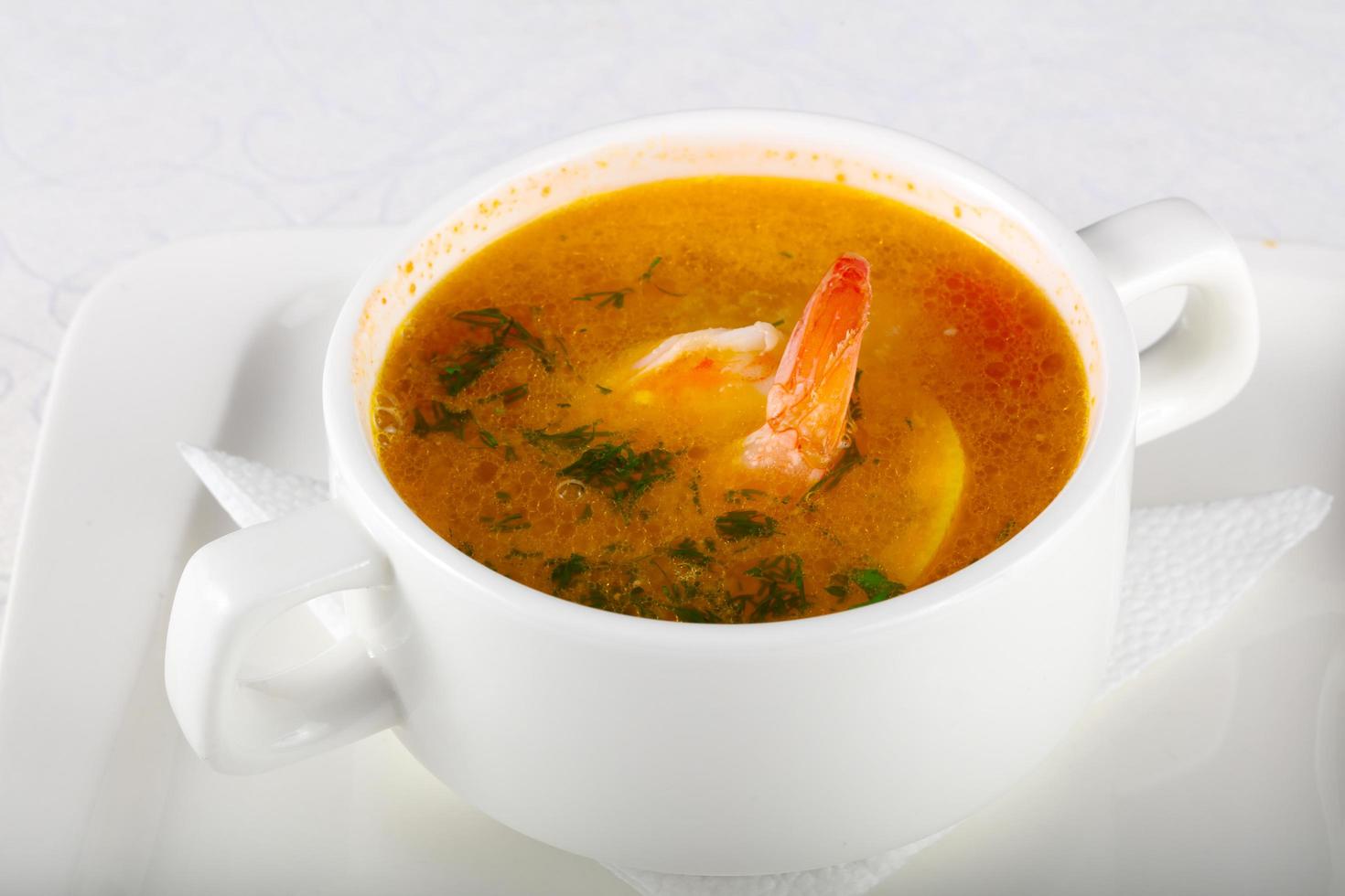 Prawn soup in a bowl on white background photo