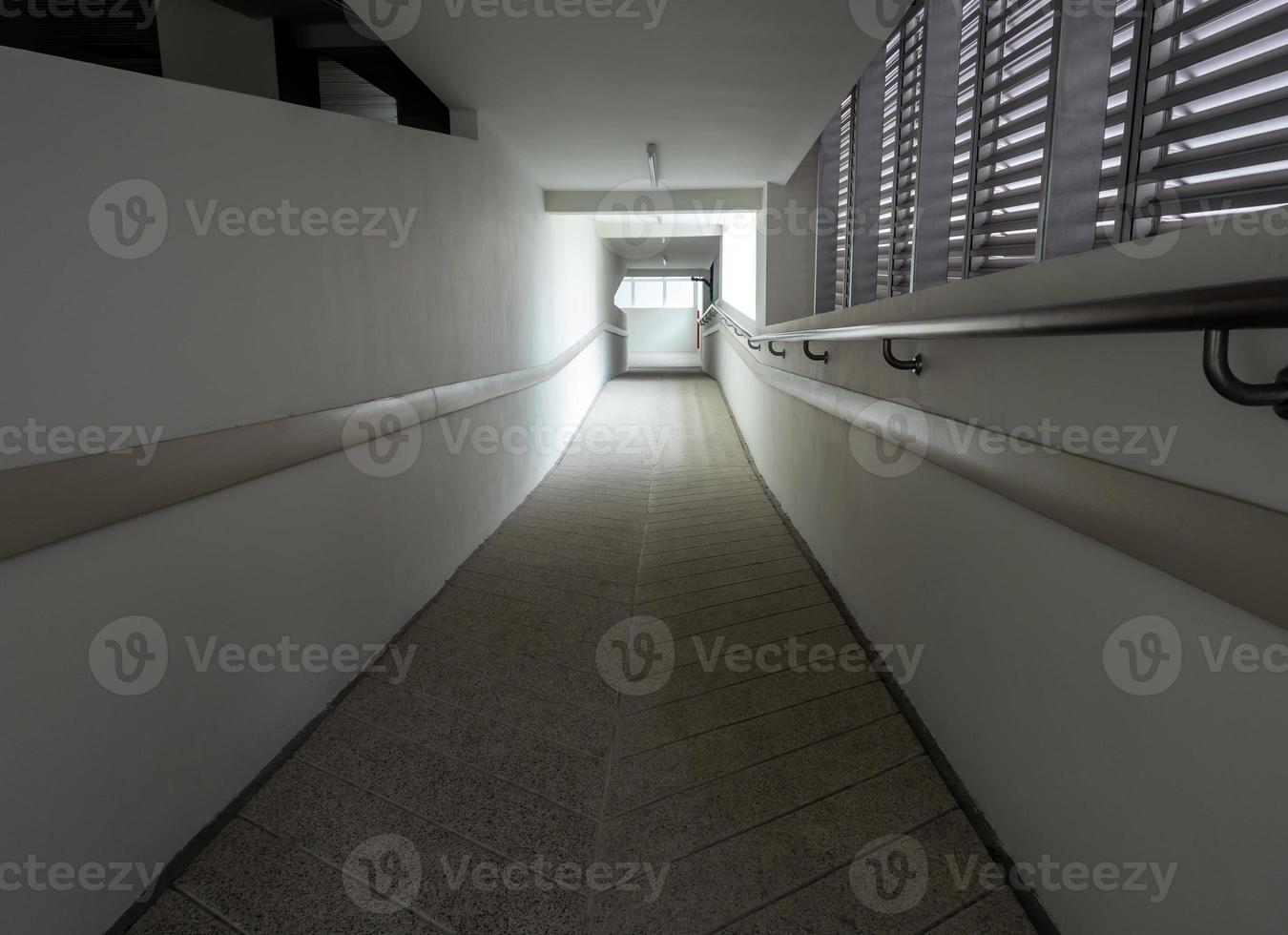 Light at the exit of the corridor in the building photo