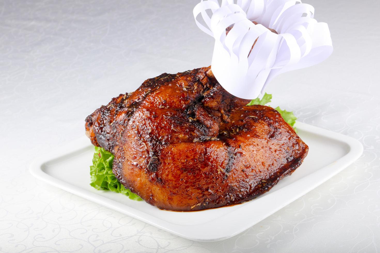 Pork leg on the plate and white background photo