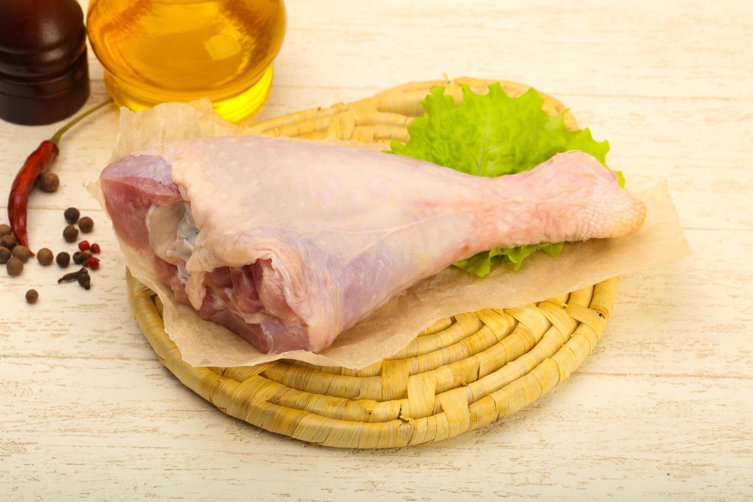 Turkey leg on wooden board and wooden background photo