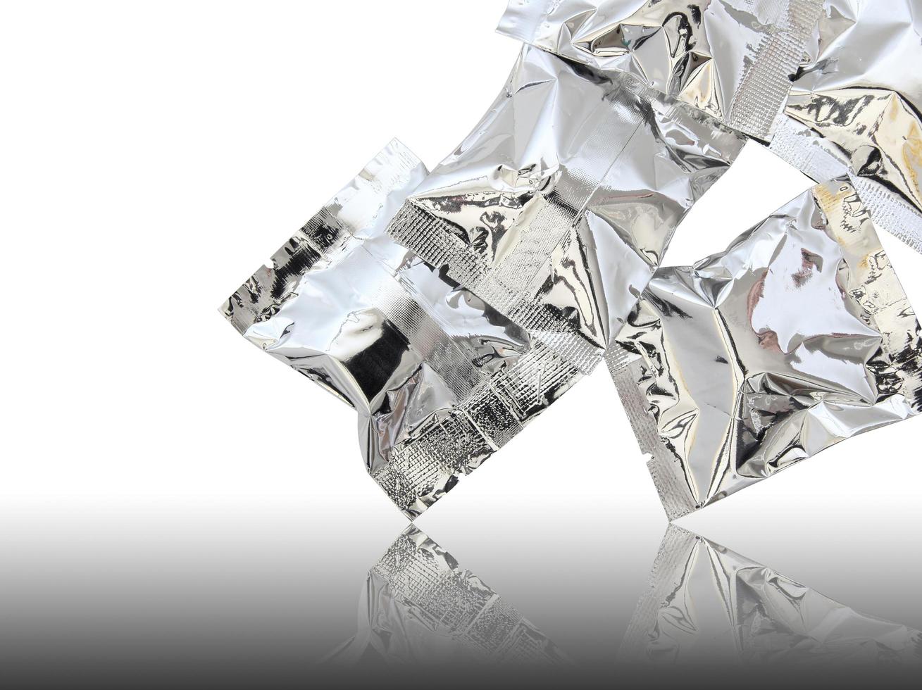 Foil package on reflect floor and white background photo