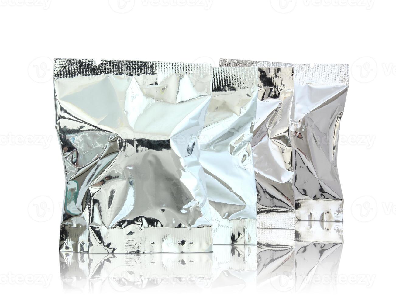 paquete de aluminio en el suelo reflectante y fondo blanco foto