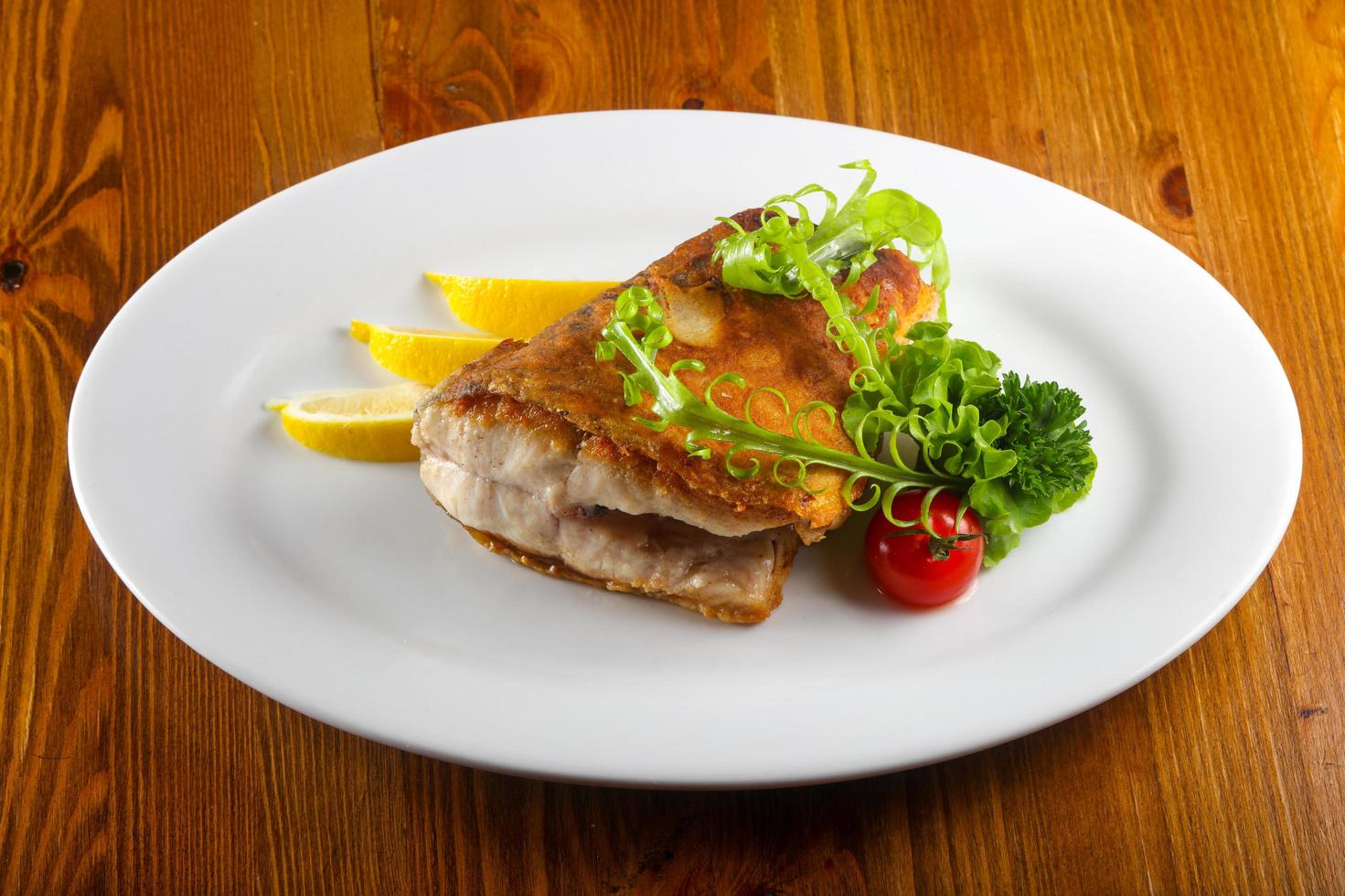 Baked salmon on the plate and wooden background photo