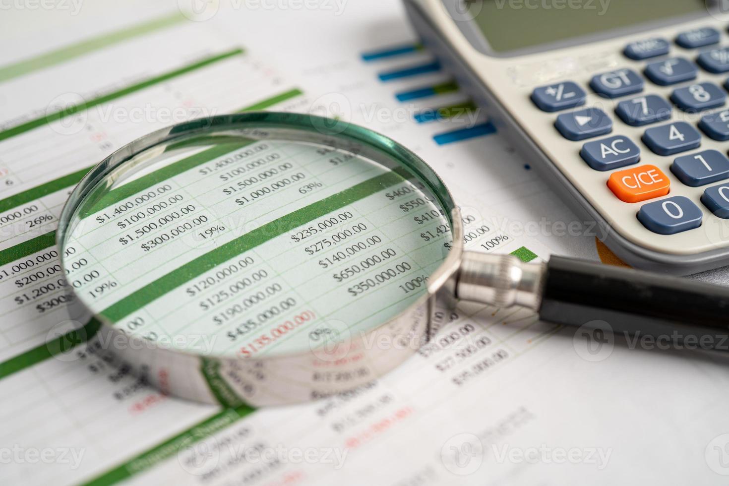 Magnifying glass on spreadsheet and calculator. Financial development, Banking Account, Statistics, Investment Analytic research data economy, Stock exchange trading, Business office concept. photo