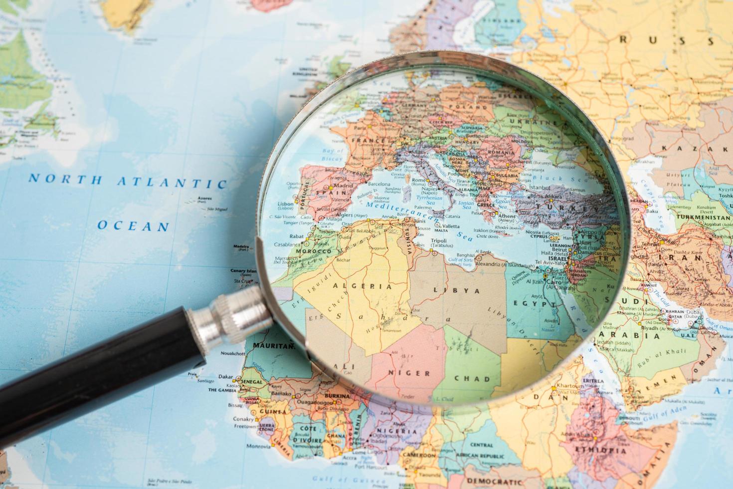 Bangkok, Thailand - May 01, 2022 Africa, Magnifying glass close up with colorful world map photo