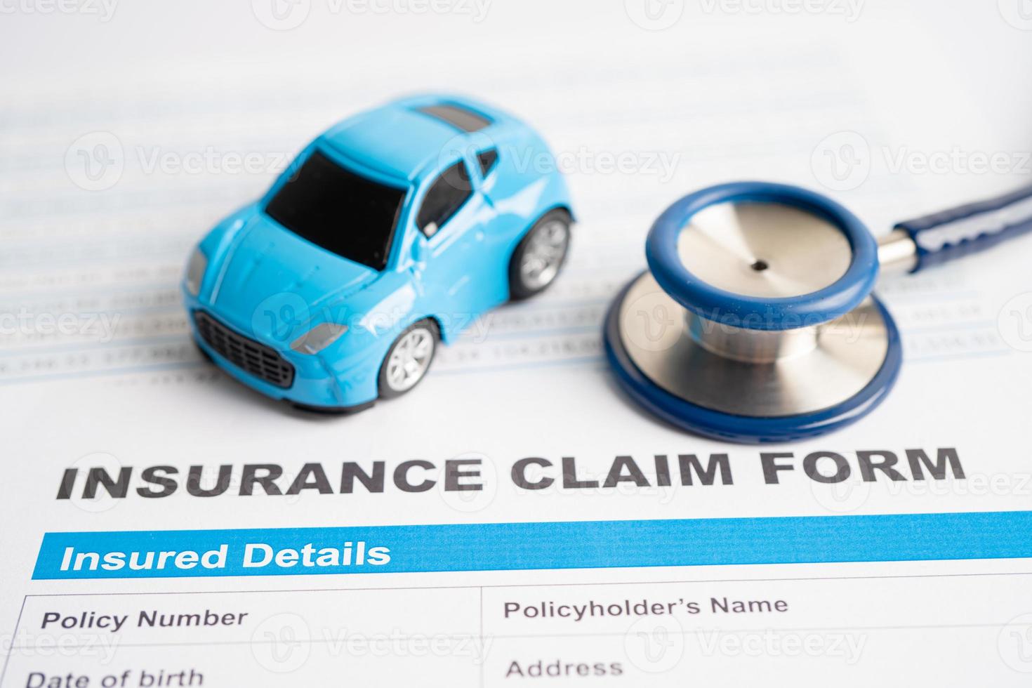 Stethoscope on Insurance claim accident car form, Car loan, insurance and leasing time concepts. photo