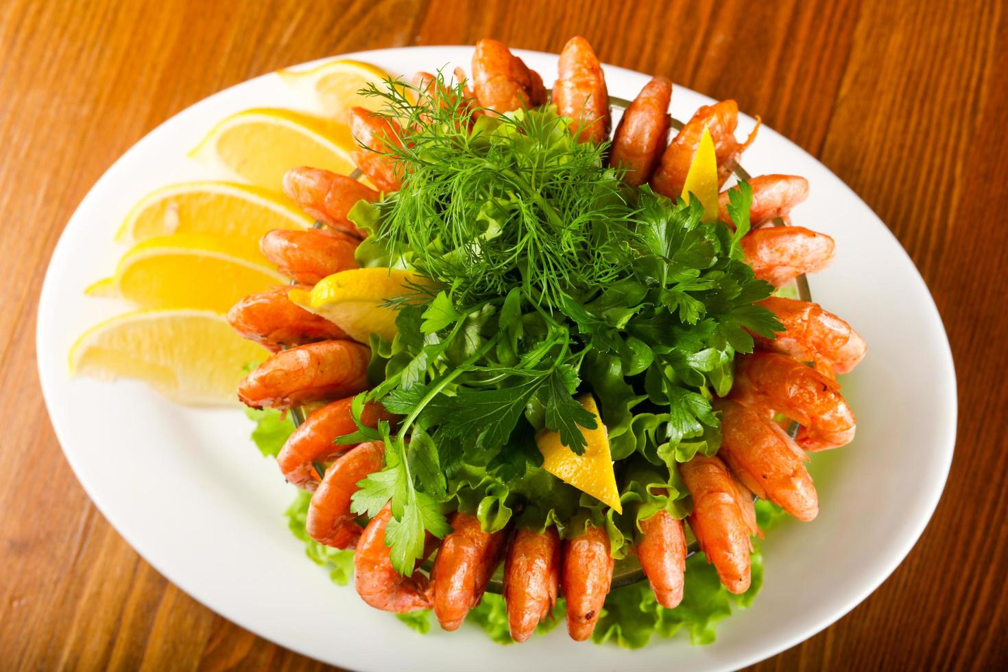 Prawn cocktail on the plate and wooden background photo