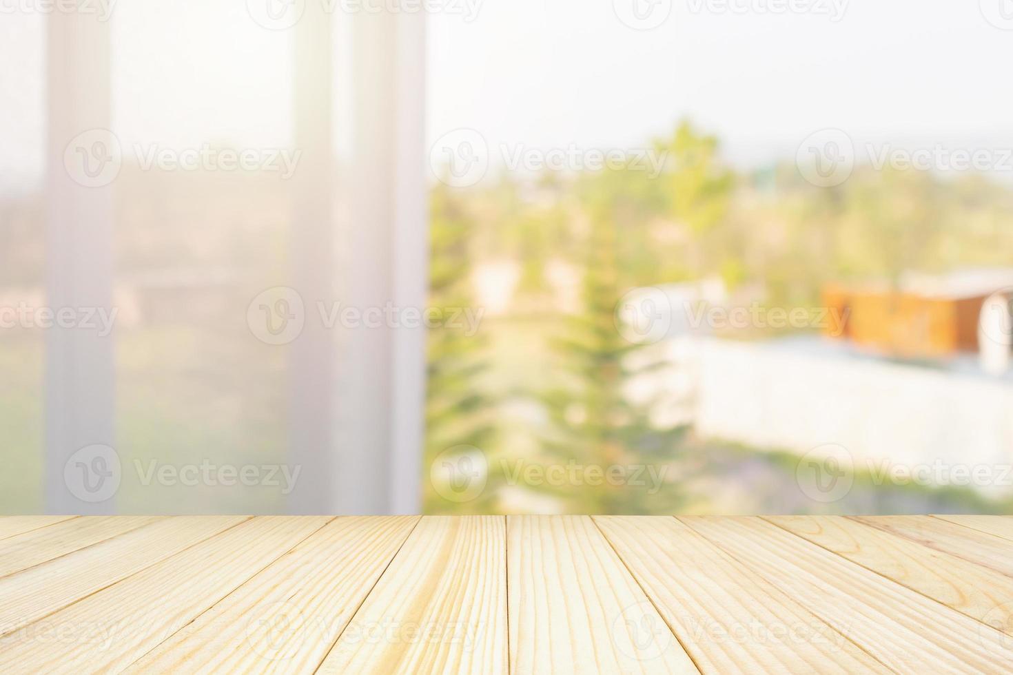 Empty wood table top with window curtain abstract blur background for product display photo