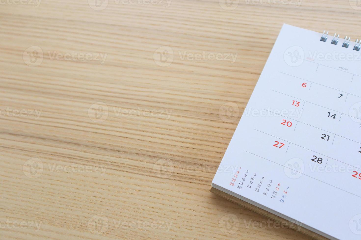 calendar page on wood table background photo